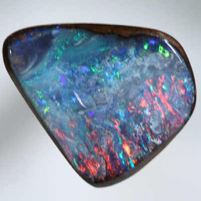 SOLID BOULDER OPAL Bright red sparkles over blue